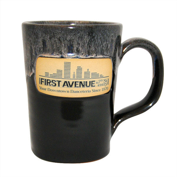 Black Deneen Pottery mug with the First Avenue logo