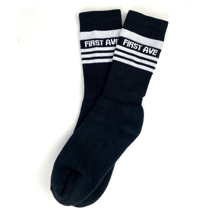 Black socks with white stripes and 'First Ave' text in white