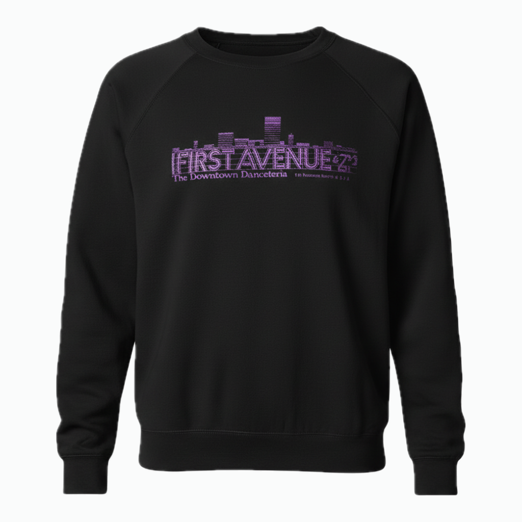 A black crewneck sweatshirt featuring a purple First Avenue logo on the chest in a stylized city skyline font.