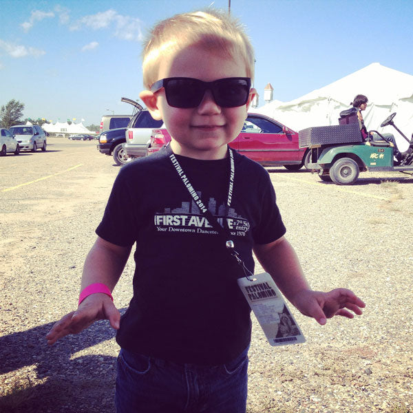 Black t-shirt with First Avenue logo in screenprinted in white on chest.