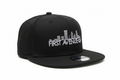 First Avenue Flatbill in black with the First Avenue logo embroidered in white on the front.