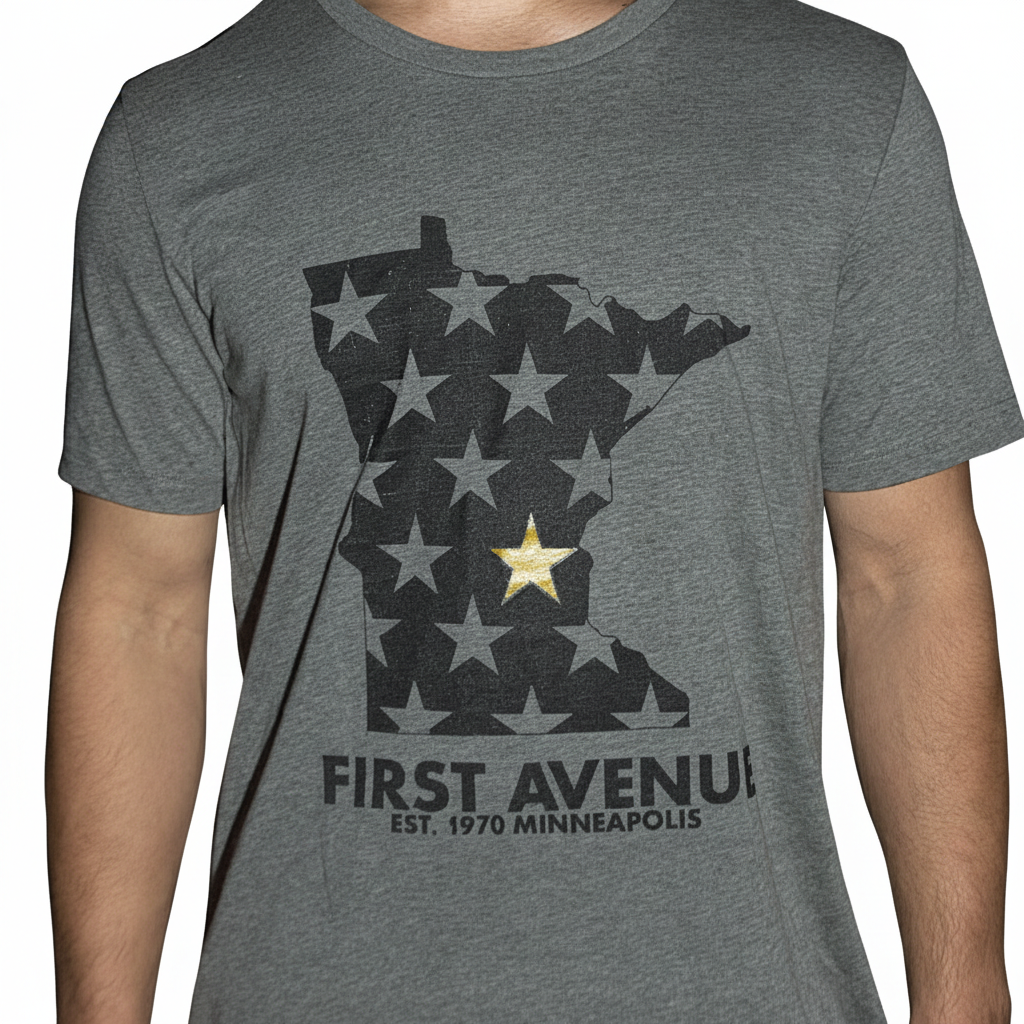 First Avenue MN Gold Star Tee in dark heathered grey. Features an image of the state of Minnesota in black with stars (one gold) and the words "FIRST AVENUE EST 1970 MINNEAPOLIS" beneath it.