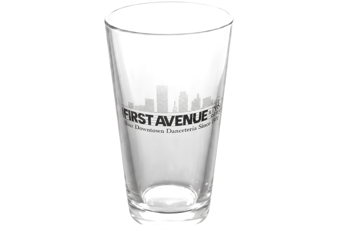 A clear pint glass featuring skyline of Minneapolis with the text 'FIRST AVENUE & 7th St Entry' and 'Downtown Danceteria Since 1970' on the front