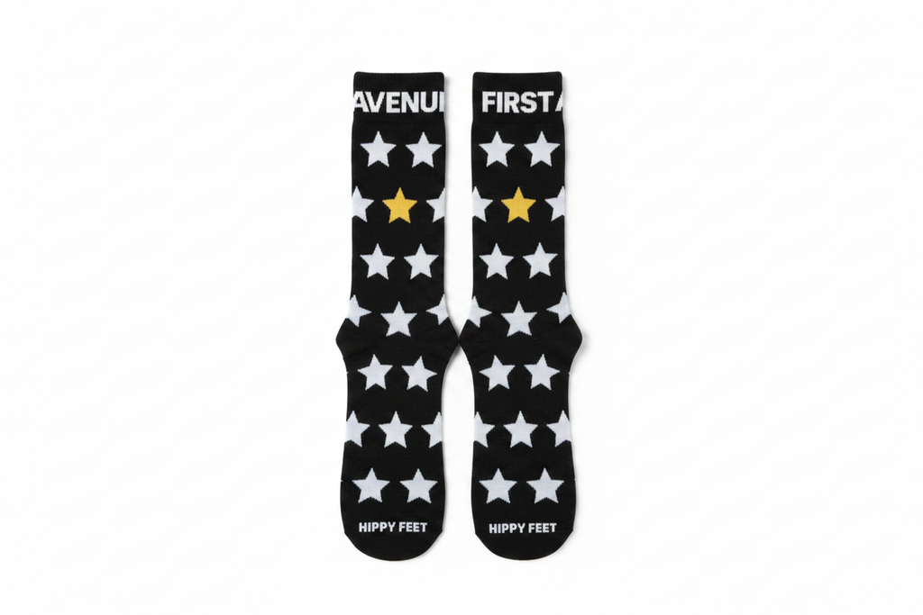 First Avenue x Hippy Feet Socks - black socks with gold and silver stars. "FIRST AVENUE' is along the top of each sock.