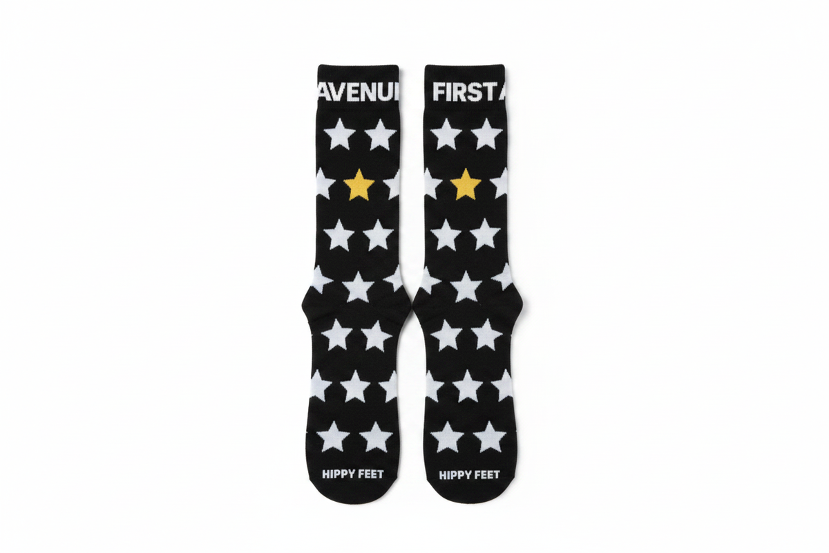 First Avenue x Hippy Feet Socks - black socks with gold and silver stars. "FIRST AVENUE' is along the top of each sock.