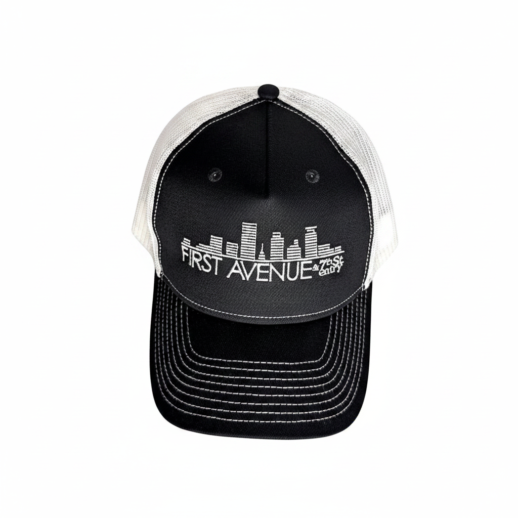 Trucker Hat in black (front) and white (mesh back) with the First Avenue logo embroidered in white on the front.