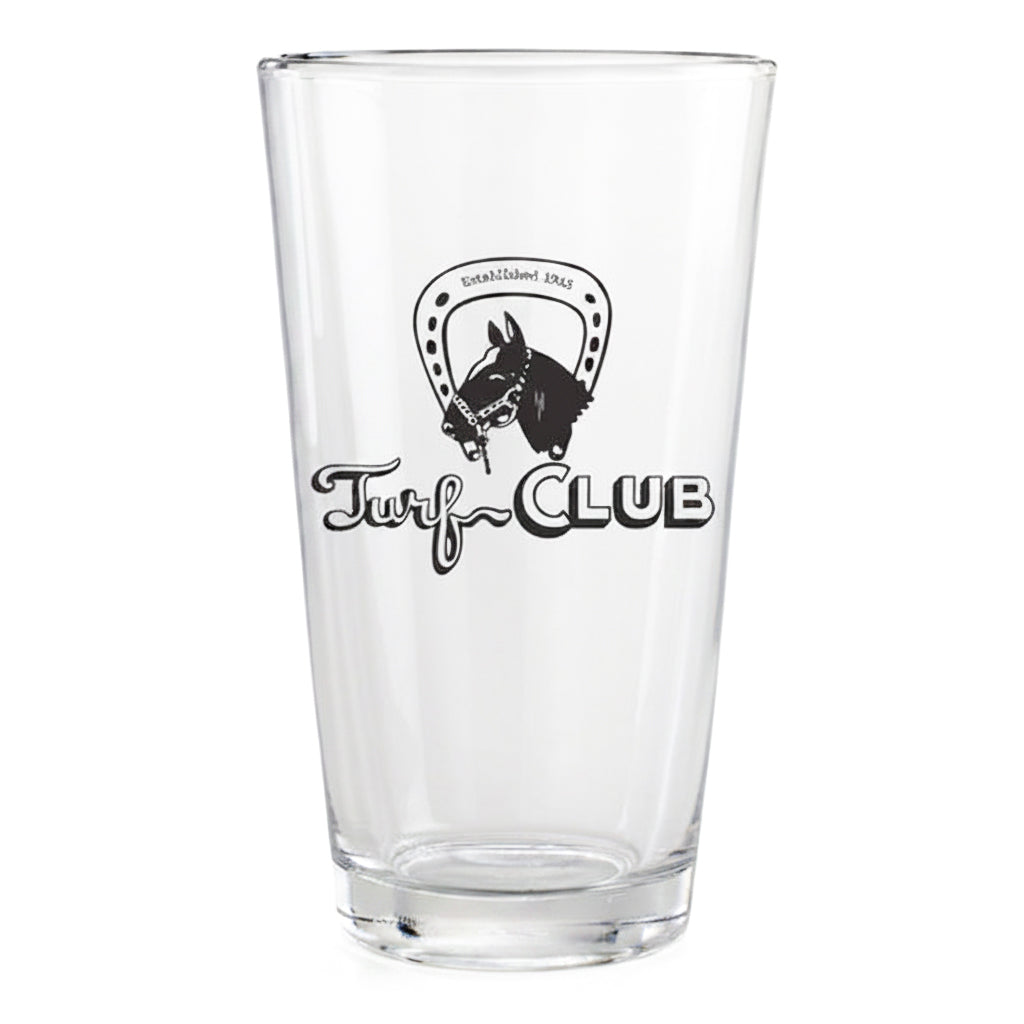 A clear glass pint glass featuring a black printed logo with a horse head inside a horseshoe and the words 'Turf CLUB'